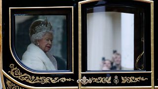 Britain's Queen Elizabeth II travels in a carriage to parliament for the official State Opening of Parliament in London, Monday, Oct. 14, 2019.