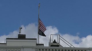 The US flag flying at half-mast over the White House