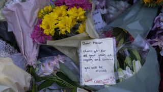 Mourners lay flowers at the gates of Buckingham Palace in London, Friday, Sept. 9, 2022.