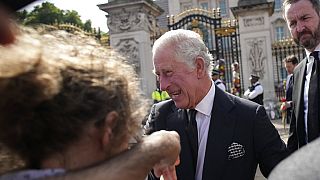 King Charles III greets mourners outside Buckingham Palace