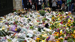 People lay flowers at Windsor Castle following the Queen's death
