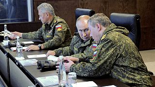 Russian President Vladimir Putin speaks to General Staff chief, Gen. Valery Gerasimov during the Vostok 2022 military exercises on 6 September 2022