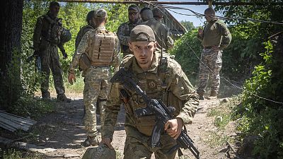 Ukrainian soldiers attend their positions, in the Donetsk region, 2 July 2022