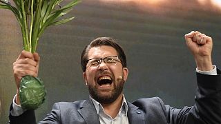 Sweden Democrats leader Jimmie Åkesson holds flowers and celebrates during a speech in Nacka, Sweden, early Monday 12 September 2022