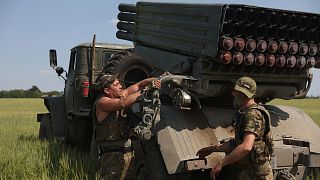 FILE - Ukrainian artillerymen prepare to fire a BM-21 Grad multiple rocket launcher near Izyum, south of Kharkiv, on 11 June 2022 