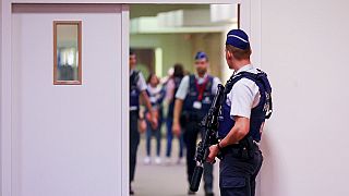 Security officer patrols during the preliminary hearing, for the Brussels attacks that took place on March 22, 2016, at the Justitia building in Brussels