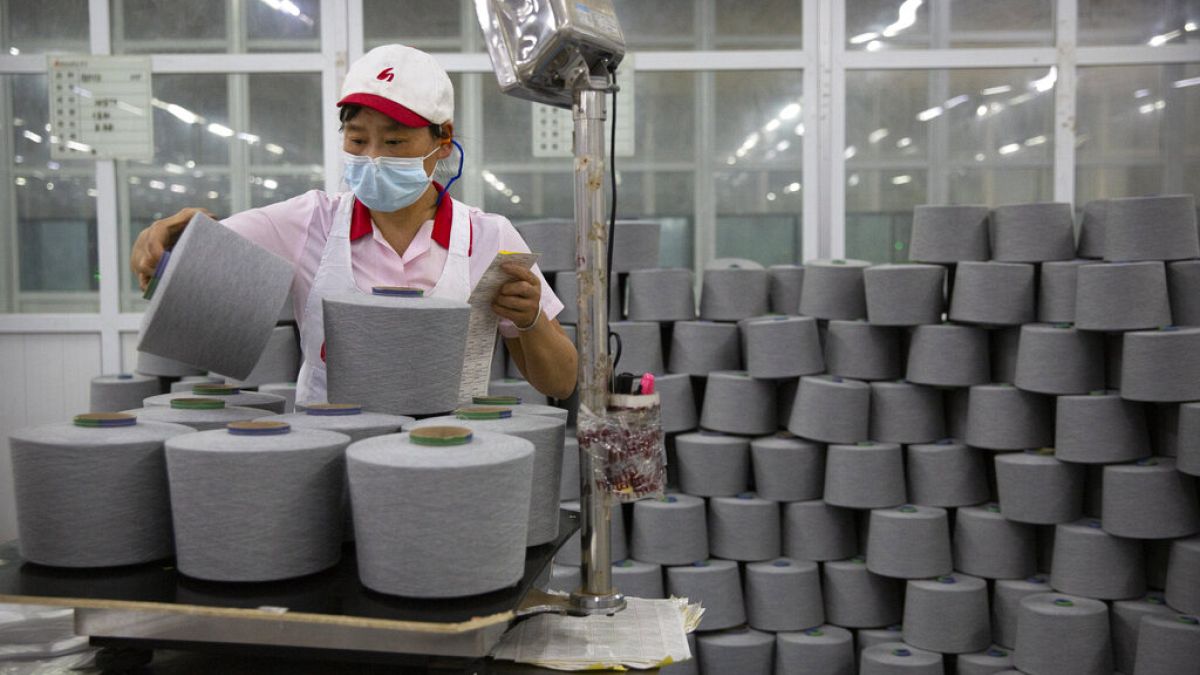 A worker packages spools of cotton yarn at a Huafu Fashion plant, as seen during a government organized trip for foreign journalists, in Aksu in China's Xinjiang Region.