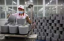 A worker packages spools of cotton yarn at a Huafu Fashion plant, as seen during a government organized trip for foreign journalists, in Aksu in China's Xinjiang Region.