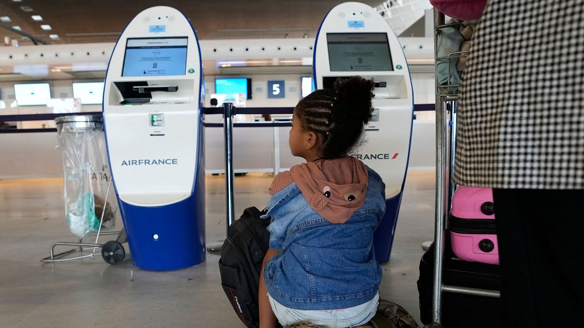 Travellers wait at empty check in desks on Friday, 16 September. Air traffic controllers will go on strike today, grounding half of flights going in and out of France