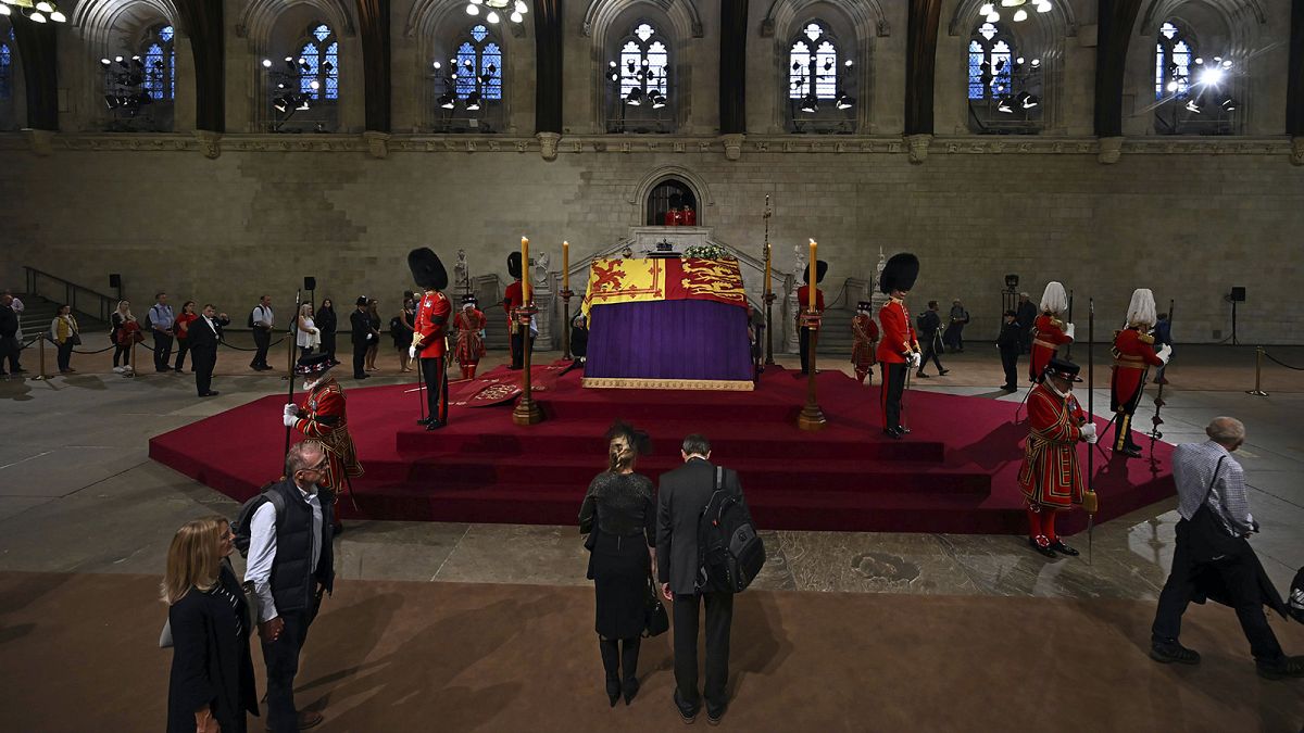 Members of the public file past the coffin of Queen Elizabeth II, inside Westminster Hall, at the Palace of Westminster, in London on 14 September 2022