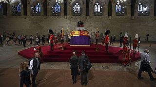 Members of the public file past the coffin of Queen Elizabeth II, inside Westminster Hall, at the Palace of Westminster, in London on 14 September 2022