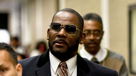 Musician R. Kelly, center, leaves the Daley Center after a hearing in his child support case on May 8, 2019, in Chicago.