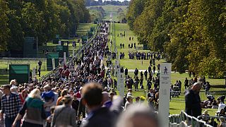 People make their way along the Long Walk towards Cambridge gate outside Windsor Castle to lay flowers for the late Queen Elizabeth II in Windsor, England, Saturday, Sept. 17,