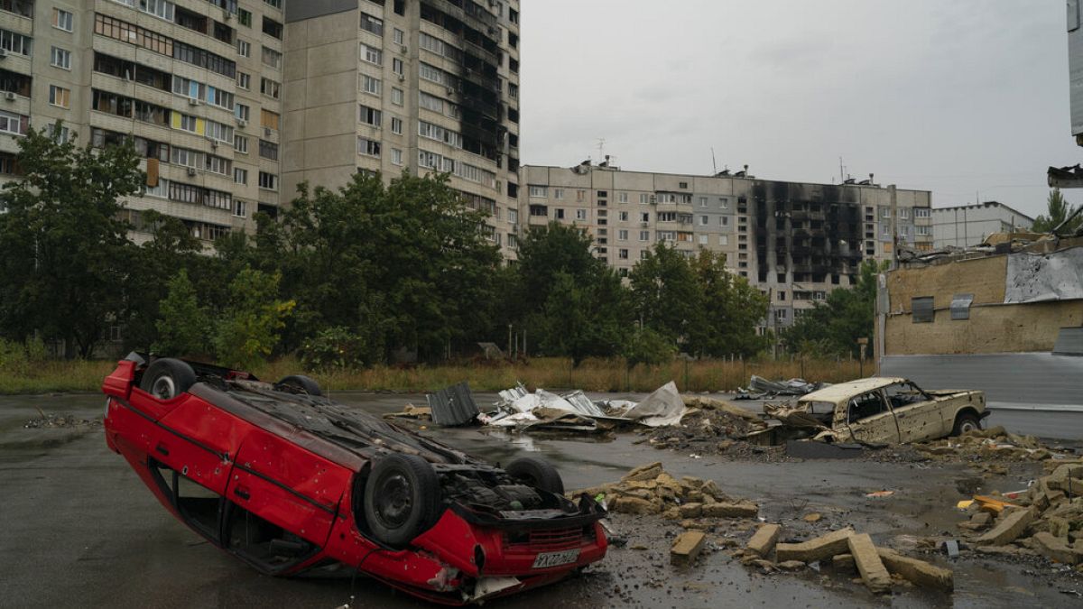 Destroyed cars are seen in an area next to apartment buildings that have been heavily damaged by Russian attacks on previous months at in Kharkiv, Ukraine. 