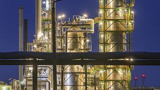 The facilities of the oil refinery on the industrial site of PCK-Raffinerie GmbH, jointly owned by Rosneft, are illuminated in the evening in Schwedt, Germany.