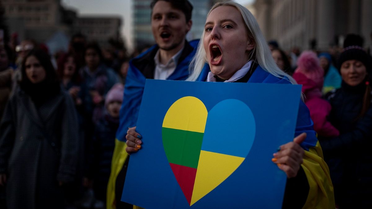 People take part in a protest against the Russian invasion of Ukraine at Independence Square at the Parliament Palace in Vilnius, Lithuania, Thursday, March 24, 2022