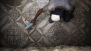 فلسطيني يزيل الغبار عن جزء من أرضية فسيفسائية في غزة تعود إلى العصر البيزنطي. 2022/09/05