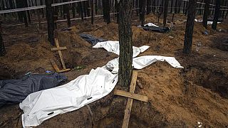 Bags with dead bodies are seen during the exhumation in the recently retaken area of Izium, Ukraine, Friday, Sept. 16, 2022.