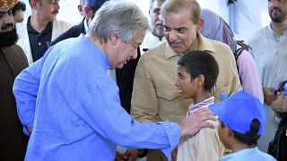 El primer ministro Shahbaz Sharif y el secretario general de la ONU, Antonio Guterres interactúan con niños en una escuela en Jaffarabad, Pakistán, el sábado 10 de septiembre.