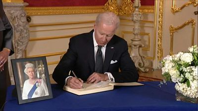 US president Joe Biden signing condolences book