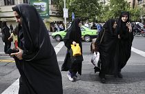 Iranian women wearing headscarves crossing a street in Tehran, Iran. Sunday, 22 April 2018.