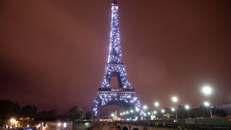 This file photograph taken on November 10, 2018, shows an illuminated Pont d'Iena leading to The Eiffel Tower in Paris.