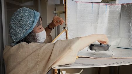 Chikako uses the sun's energy to cook her food