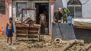 Neighbours work to recover their belongings from the flooding caused by Hurricane Fiona in Higüey, Dominican Republic, Tuesday, 20 September 2022
