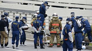 Police and firefighters inspect the scene where a man is reported to set himself on fire, 21 September 2022