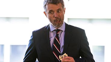 Frederik, Crown Prince of Denmark tries a cricket cookie at a sustainable food conference in New York.