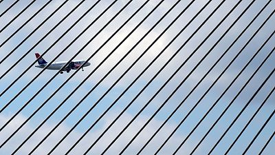 An Air Serbia passenger plane flies over Ada bridge over the Sava river, before landing in Belgrade, Serbia, Aug. 6, 2021.