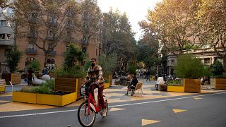 A man rides a bicycle in a pedestrian area as part of an expansion of the "superilla" (superblock) plan promoting cycling and car-free zones in Barcelona on November 14, 2020.
