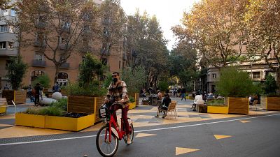 A man rides a bicycle in a pedestrian area as part of an expansion of the "superilla" (superblock) plan promoting cycling and car-free zones in Barcelona on November 14, 2020.