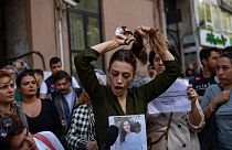 Nasibe Samsaei, an Iranian woman living in Turkey, cuts her ponytail off during a protest outside the Iranian consulate in Istanbul on September 21, 2022.