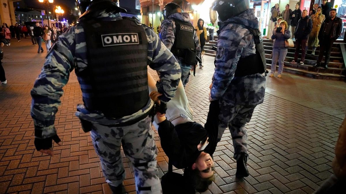 Riot police detain a demonstrator during a protest against mobilization in Moscow, Russia, Wednesday, Sept. 21, 2022.