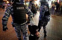 Riot police detain a demonstrator during a protest against mobilization in Moscow, Russia, Wednesday, Sept. 21, 2022.