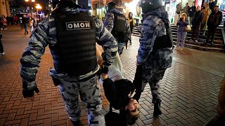 Riot police detain a demonstrator during a protest against mobilization in Moscow, Russia, Wednesday, Sept. 21, 2022.
