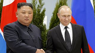 Russian President Vladimir Putin and North Korea's leader Kim Jong Un shake hands during their meeting in Vladivostok in 2019