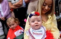 A woman and her baby watch the Twelfth of July Orange Order celebrations in the city centre of Belfast, Northern Ireland July 12, 2022