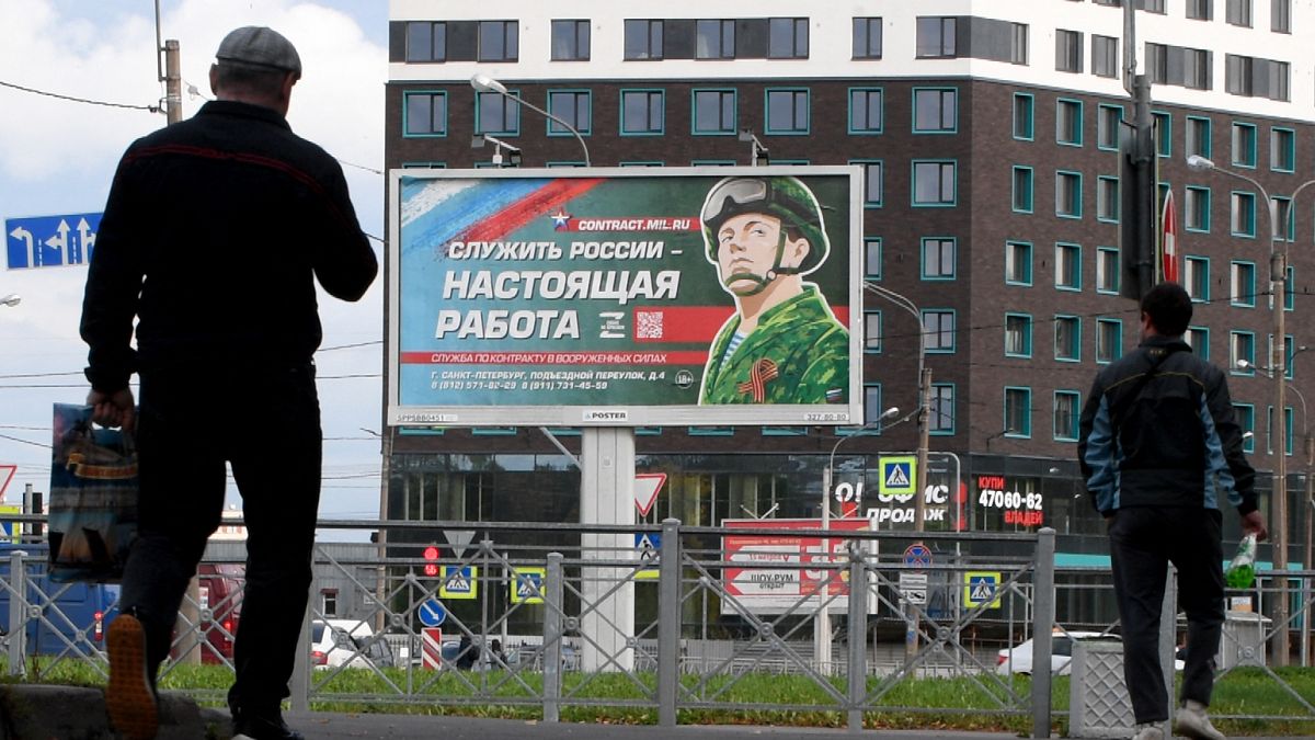 In this photo taken on September 20, 2022 a billboard promoting contract army service with an image of a serviceman and the slogan reading "Serving Russia is a real job".