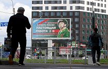 In this photo taken on September 20, 2022 a billboard promoting contract army service with an image of a serviceman and the slogan reading "Serving Russia is a real job".