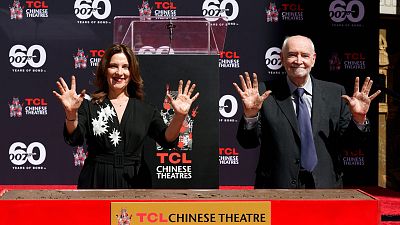 Michael G. Wilson and Barbara Broccoli have their hands imprinted during a ceremony at the TCL Chinese Theatre