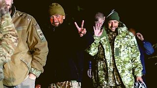 Ukrainian soldiers, who were released in a prisoner exchange between Russia and Ukraine, smile close to Chernihiv, Ukraine, late Wednesday, Sept. 21, 2022. 