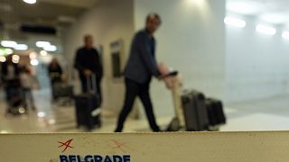 Passengers pass through the airport building in Belgrade, Serbia, Wednesday, Sept. 21, 2022. Many Russians booked one-way tickets out of the country while they still could.