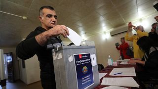 A man from Luhansk region, the territory controlled by a pro-Russia separatist government, but who lives in Russia, votes at temporary facility in Volgograd, Russia