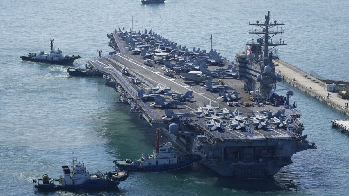 The U.S. carrier USS Ronald Reagan is escorted as it arrives in Busan, South Korea, Friday, Sept. 23, 2022.
