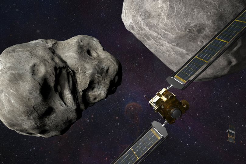 This illustration made available by Johns Hopkins APL and NASA depicts NASA's DART at the Didymos system before impact with the asteroid Dimorphos. Sep 13, 2022