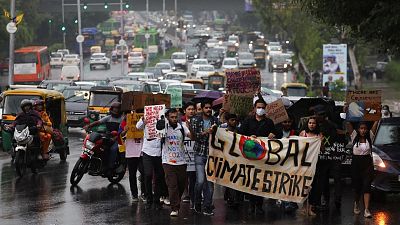 People take part in a "Global Climate Strike" march towards the Delhi Secretariat building, calling for urgent measures to combat climate change.