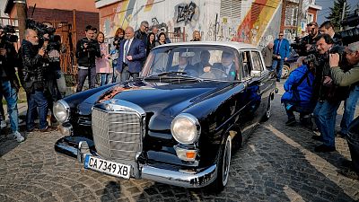 Bulgarian ex-Premier Boiko Borisov, leader of the center-right GERB party, drives a vintage Mercedes as he leaves a voting station, in Sofia, Bulgaria, Sunday, March 26, 2017.