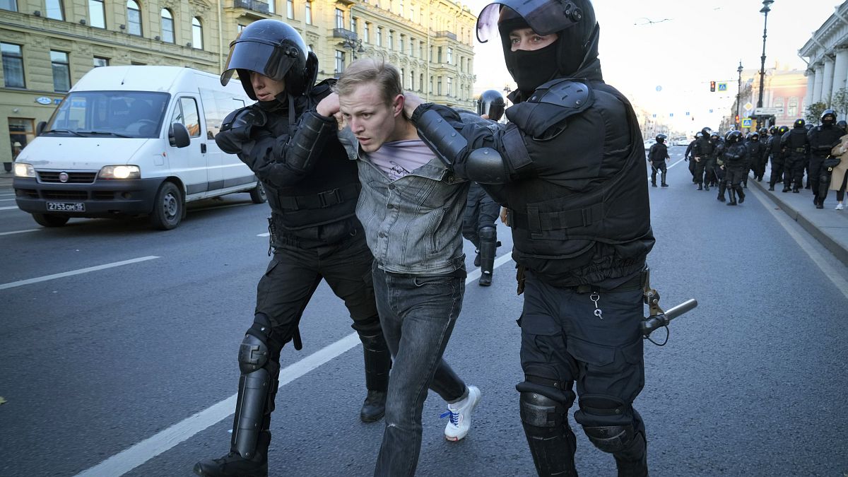 Russian policemen detain a demonstrator protesting against mobilization in St. Petersburg, Russia, Saturday, Sept. 24, 2022. 